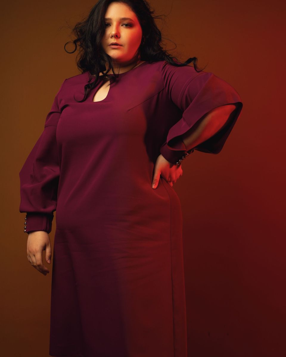 Style photo: a maroon dress similar in mood to the Azazie Leonia Long-Sleeve Stretch Satin Gown
